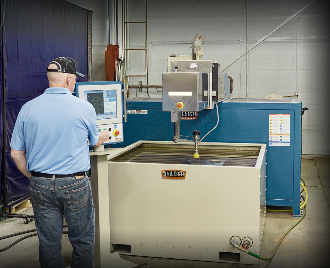 A worker at a Baileigh Water Jet